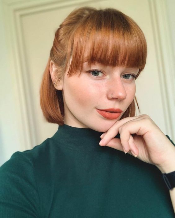 a chin-length ginger bob with a classic fringe styled as a half updo is a lovely idea with a slight retro feel