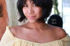 a flirty black jaw-line bob with wispy and bottleneck bangs plus curved ends is a very cute and lovely idea