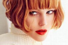 a ginger ear-length bob with a thick classic fringe and waves is a super bold and eye-catching idea that wows