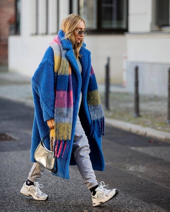 a grey sweatshirt and sweatpants, white trainers, a blue faux fur coat and a colorful scarf are great for a bold winter look