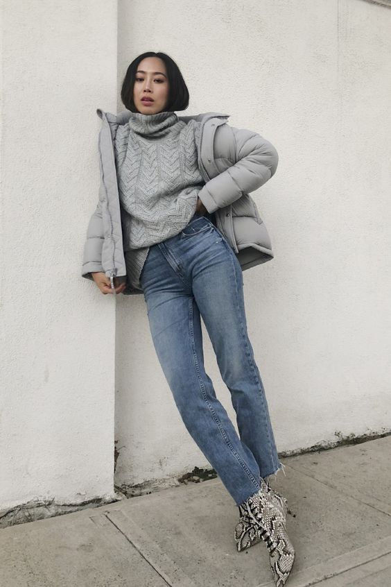 a grey winter look with a patterned sweater, a cropped puffer jacket, snakeskin print boots and blue jeans
