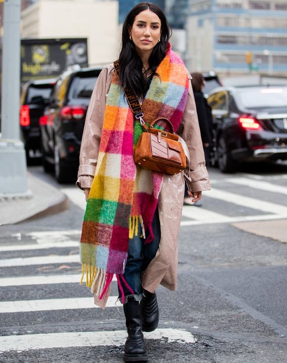a lacquer pink leather trench, blue jeans, black boots, a colorful plaid scarf and an orange bag for a bold winter look