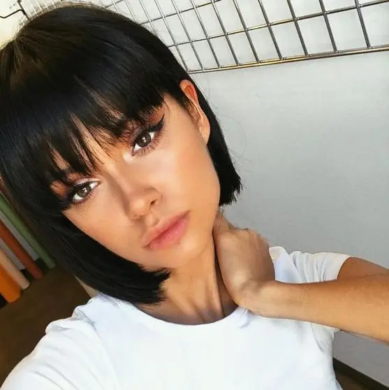 a lovely black boy bob with bangs for a super cute, doll like look is a timeless idea