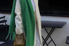 a neutral winter outfit with a green scarf