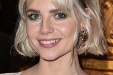 a platinum blonde chin-length bob with curtain bangs and waves styled as a half updo is a catchy idea