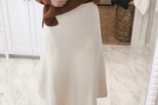 a pretty Thanksgiving look with a rust-colored chunky knit sweater, a creamy A-line midi skirt, rust shoes