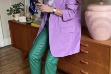 a refined and bright fall work look with a white t-shirt, an oversized purple blazer, green leather pants, electric blue heeled mules