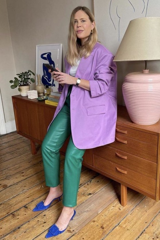 a refined and bright fall work look with a white t-shirt, an oversized purple blazer, green leather pants, electric blue heeled mules