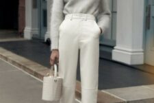 a refined outfit with a grey oversized angora sweater, white high waisted cropped leather pants, printed shoes and a white bucket bag