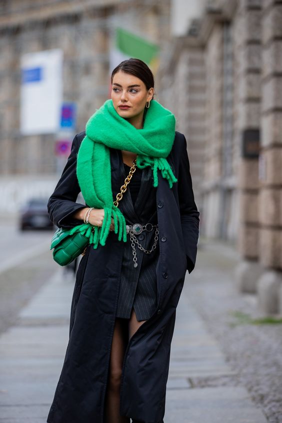 a refined winter outfit with a black blazer mini dress, a chain belt, a black coat, a bold green scard and a bag on chain