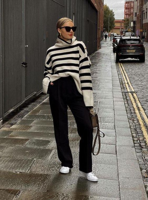 a timeless outfit with a Breton stripe sweater, black pants, white sneakers and a brown bag will work for any situation