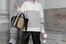 a white Breton stripe sweater, black leather pants, black boots, a woven bag with black ribbon