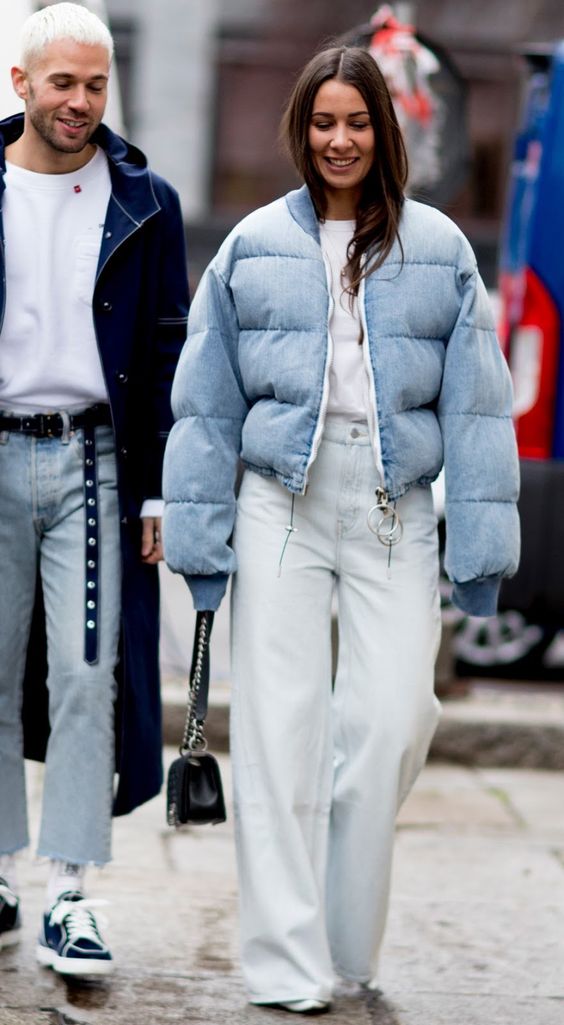 a white top, bleached wide leg jeans, white trainers, a light blue cropped puffer and a black bag for a lovely winter look