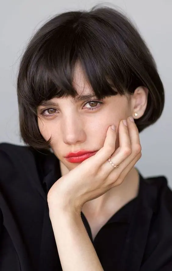 an ear-length bob with a classic fringe in black is a beautiful Parisian chic infused hairstyle