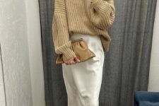 an elegant Thanksgiving outfit with a tan chunky knit sweater, a creamy silk midi, tan cowboy boots
