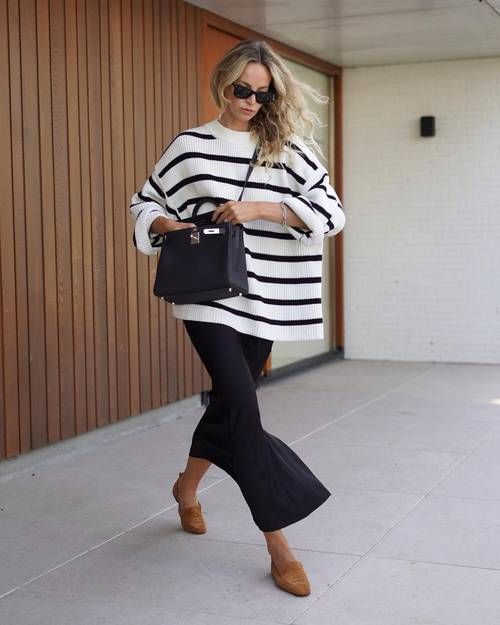 an oversized Breton stripe sweater, a black maxi skirt, brown loafers and a black bag for a chic office look