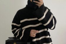 an oversized black Breton stripe sweater, black pants, a black bag are a comzy and comfy winter work look