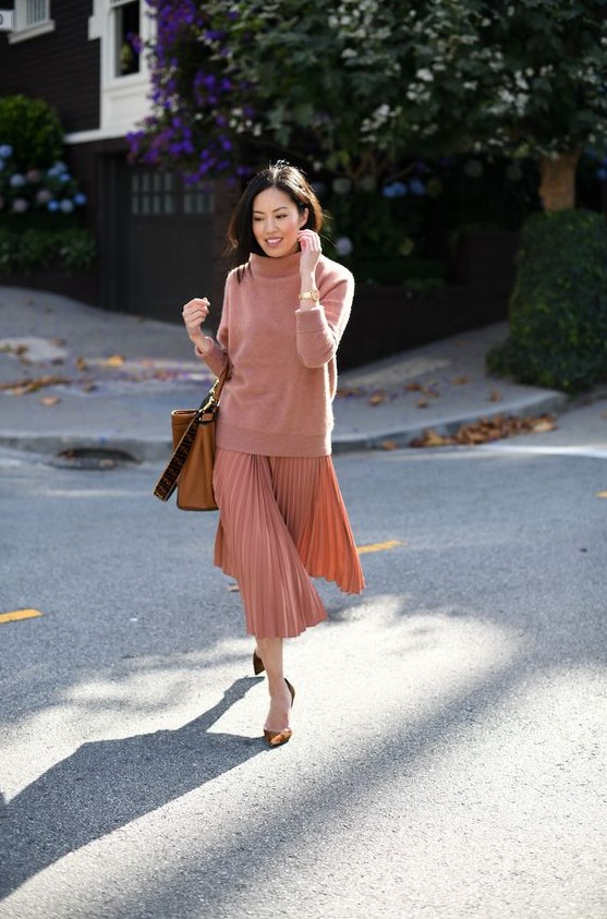 an oversized coral sweater, a matching pleated midi and brown velvet shoes plus an amber bag