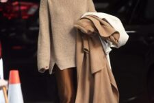 an oversized tan sweater, a brown silk midi skirt, tan loafers and a beige coat are great for Thanksgiving