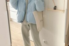 pastel winter look with a pastel green hoodie and sweatpants, a pastel blue cropped puffer jacket, neutral trainers and a tote