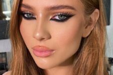 siren eyes makeup with super bold and accented eyes with a foxy eye effect, a glossy pink lip and a touch of blush plus a bit of highlighter