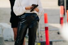 09 a white ribbed V-neckline sweater, black coroc leather pants, kitten heels, a chain necklace are a fresh take on classics