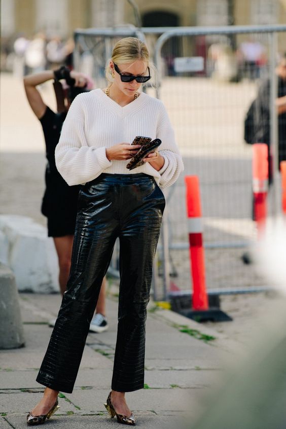 a white ribbed V-neckline sweater, black coroc leather pants, kitten heels, a chain necklace are a fresh take on classics