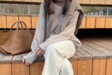 10 a tan oversized sweater, a greige oversized sweater on top, white jeans, black boots and a beige tote for work