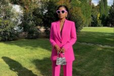 12 a magenta pantsuit with an oversized blazer, a printed mini bag and sunglasses in a lilac frame are a nice and bold look