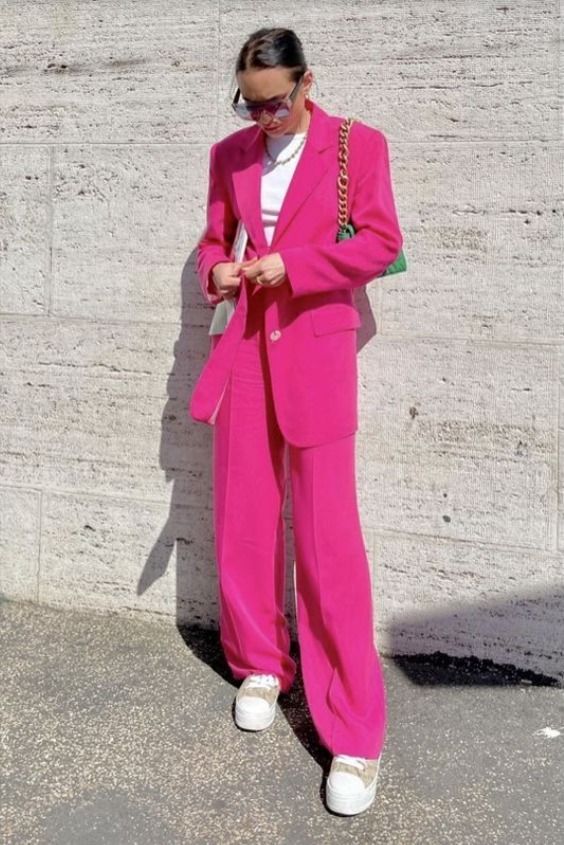 a magenta pantsuit with an oversized blazer, a white t shirt, white sneakers, a green bag on chain are amazing for work