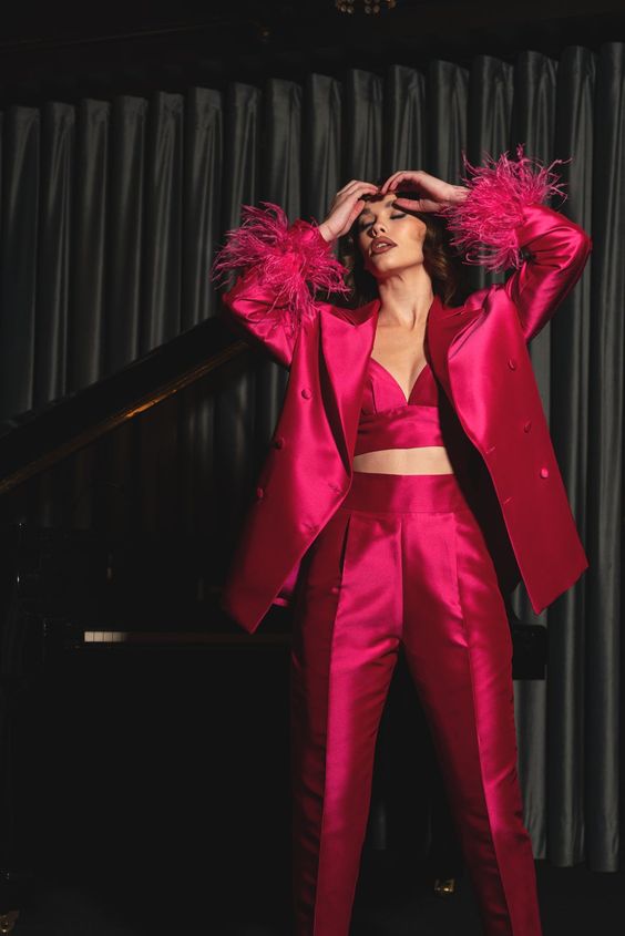 a fantastic magenta outfit with a pantsuit with an oversized blazer with feathers and a crop top is a gorgeous idea for the holidays