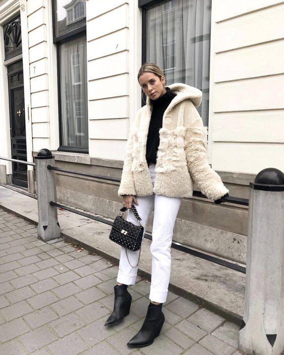 a black turtleneck, white jeans, black boots, a neutral faux fur coat, a black bag are lovely for winter