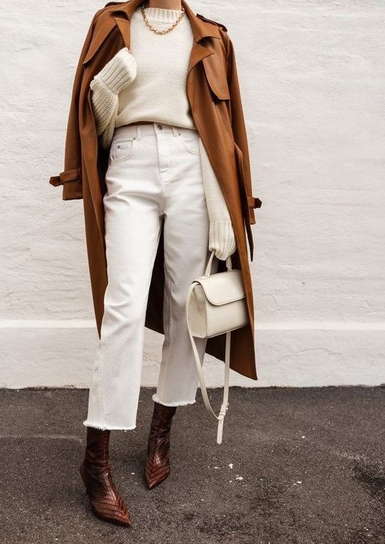 a white jumper, white cropped jeans, brown snakeskin print boots, a brown leather trench and a creamy bag