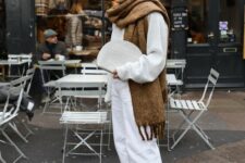 28 a white oversized sweater, white jeans, an oversized brown scarf and brown tracking boots, a white clutch