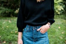 An outfit with a black three quarter sleeve sweater and a denim mini skirt