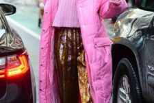 Gigi Hadid wearing a pink cropped sweater, leopard print vinyl pants, slipons and a hot pink puffer coat