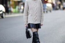 With beige knitted loose sweater and black leather bag