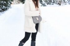 With beige shirt, black skinny pants, gray leather bag and black flat boots