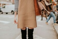 With black and white striped turtleneck, brown leather tote bag and beige coat