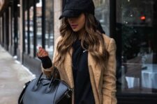 With black sweatshirt, black leather leggings and black leather tote bag