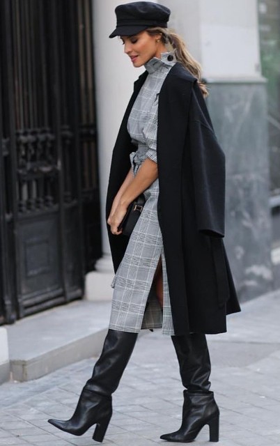 With gray and white checked belted midi dress, black leather clutch and black leather high boots