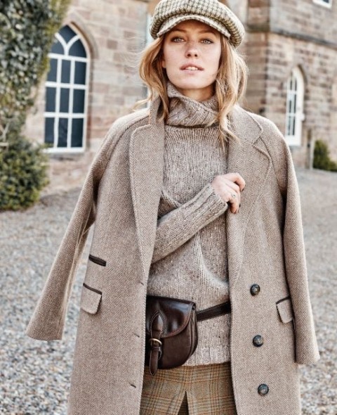 With gray loose turtleneck sweater, dark brown leather waist bag and checked tweed skirt