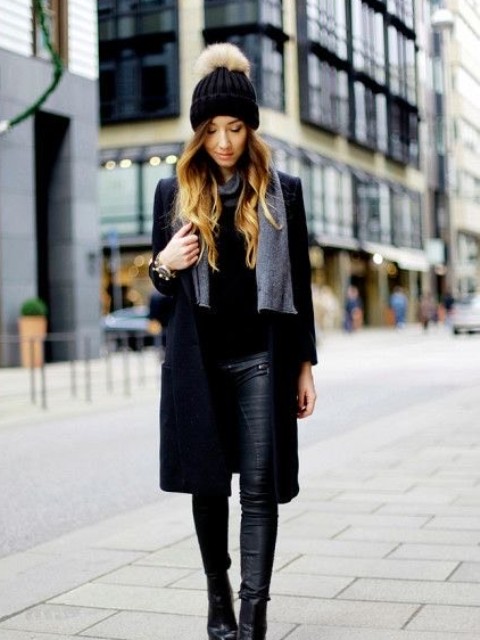 With gray scarf, black leather skinny pants, black leather ankle boots and black sweater