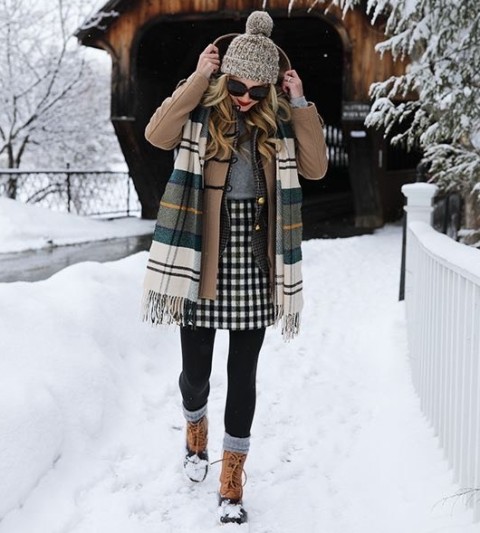 With gray sweater, black and white checked mini skirt, black tights, gray socks, sunglasses, checked fringe scarf and brown and black lace up flat boots