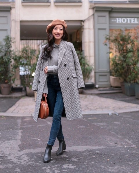 With gray turtleneck, cropped skinny jeans, brown leather rounded bag and black low heeled boots