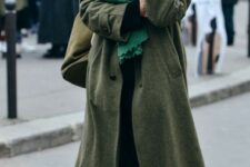 With green scarf, black shirt, olive green bag, black jogger pants and brown leather flat shoes