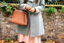 With light blue coat and brown leather tote bag