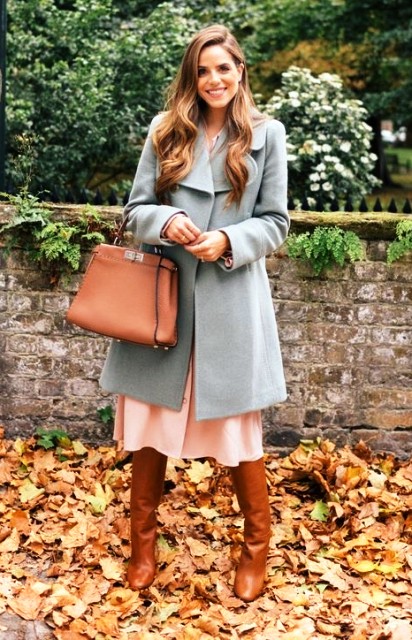 With light blue coat and brown leather tote bag