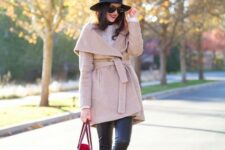 With sweater, black leather skinny pants, high heeled boots, sunglasses and marsala leather tote bag