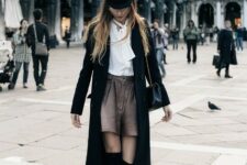 With white button down blouse, gray high-waisted shorts, black leather chain strap bag and black suede over the knee low heeled boots